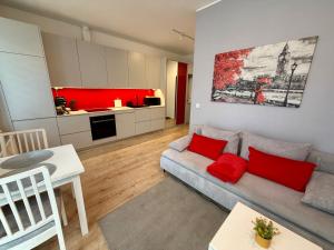 a living room with a couch and a kitchen at Apartment Targowa L9 in Lublin
