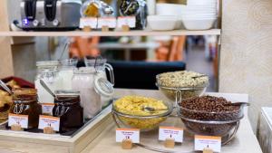 a display case with different types of food on a shelf at Star Hotel by Mellow Mood Hotels in Budapest