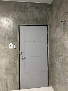 a white door in a bathroom with a shower at K-Am คราม อมตะ รีสอร์ต in Ban Yan Su +20 photos
