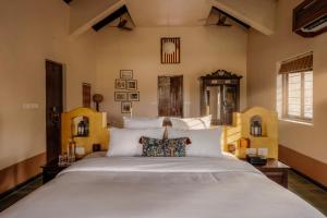 a bedroom with a large bed with white pillows at Forsté Arcangela, Sangolda in Sangolda +37 photos