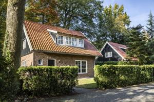 a brick house with a red roof at Boomgaard | 4-16 pers. in Losser