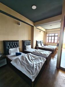 a bedroom with two beds in a room at Great Eastern Valley Residency in Gangtok