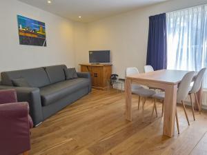 a living room with a couch and a table at Vakantiewoning Veere VE01 in Veere