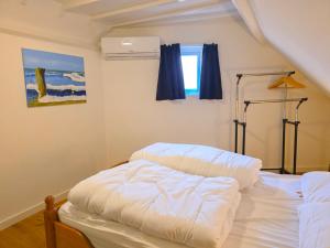 a white bed in a room with a window at Vakantiewoning Veere VE01 in Veere
