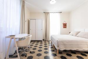 a bedroom with a bed and a desk and a table at Moleloca - Casa Bacolla in Cocconato +35 photos