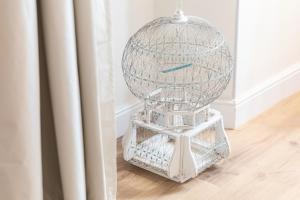 a bird cage with a clock on top of it at Moleloca - Casa Bacolla in Cocconato