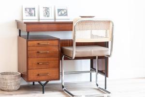 a desk with a chair next to a drawer at Moleloca - Casa Bacolla in Cocconato