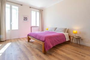 a bedroom with a large bed with a purple blanket at Moleloca - Casa Bacolla in Cocconato