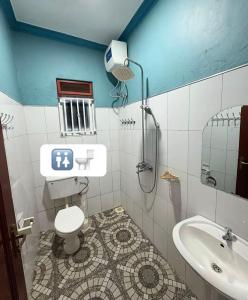a bathroom with a toilet and a shower and a sink at Serenity homes in Mukono +9 photos