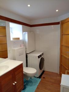 a small bathroom with a toilet and a refrigerator at Gite Ti Maen in Sulniac +8 photos