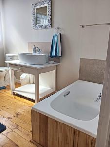 a bathroom with a sink and a bath tub at Beach Walk by Salted Fynbos Staying in Pearly Beach +47 photos