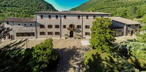 an aerial view of a large stone building with trees at Villa Benveduti in Gubbio