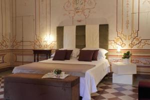 a bedroom with a large bed and a table at Villa Benveduti in Gubbio +33 photos