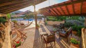a patio with chairs and a table and a hammock at Casa Olea in Priego de Córdoba +64 photos
