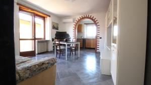 a living room with a table and a dining room at Casa Vacanza ANNA in Viverone