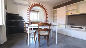 a kitchen and dining room with a table and chairs at Casa Vacanza ANNA in Viverone