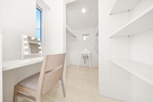 a white room with a chair and a desk at Liber 1 Tachikawa in Tachikawa +74 photos