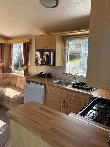 a kitchen and living room in a caravan at Bardsey View Holiday Park Nr New Quay in Llanarth