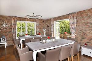 a dining room with a large table and chairs at De Regenboog in Losser +45 photos