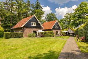 a house with a large yard with a house at De Regenboog in Losser