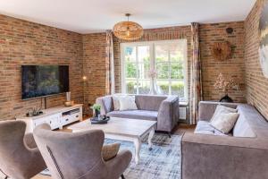 a living room with a couch and a table at De Regenboog in Losser