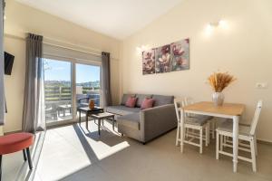 a living room with a couch and a table at ElGio Maisonette Nikiti in Nikiti