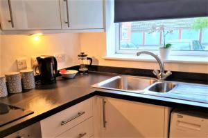 a kitchen counter with a sink and a window at K Suites - Station Road 2 in Hinckley +16 photos