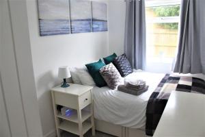 a small bedroom with a bed and a window at K Suites - Station Road 2 in Hinckley