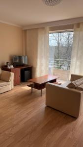 a living room with a couch and a table at Floryda in Jurata
