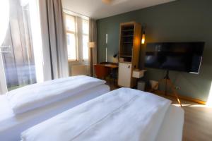 Телевізор і / або розважальний центр в Hotel Bleibtreu Berlin by Golden Tulip