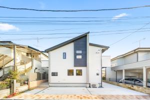 a white house with a black roof at Liber 1 Tachikawa in Tachikawa