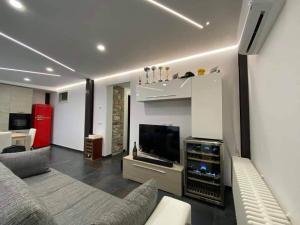 a living room with a couch and a flat screen tv at Risorgimento House in Isernia