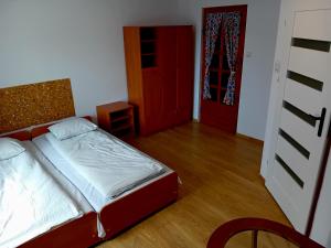 a bedroom with a bed and a red door at BERDO Noclegi i restauracja in Wetlina