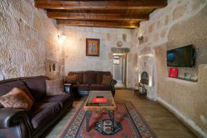 a living room with a couch and a table at Divan Cave House in Göreme