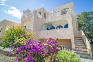 a house with purple flowers in front of it at Morans-C in Es Pujols