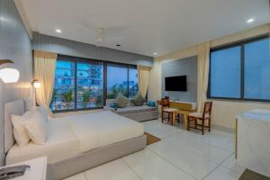a living room with a couch and a television at hotel monville akota in Vadodara