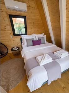 a large bed in a room with a window at Panorama Pool Hills in Ledinci +36 photos