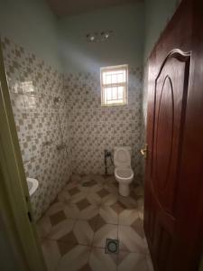 a bathroom with a toilet and a window at B-luxury stay in Ruhengeri