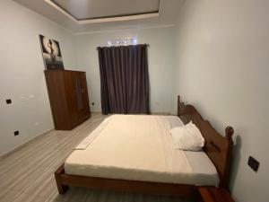 a bedroom with a large bed in a room at B-luxury stay in Ruhengeri
