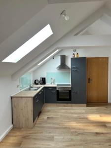 a kitchen with a sink and a stove at Halleluja mit Burgblick in Hellenthal