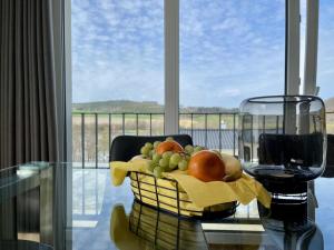 a basket of fruit on a table in front of a window at Diemelblick 22 - SEEBLICK in Heringhausen