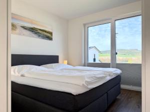 a bedroom with a large bed with a large window at Diemelblick 22 - SEEBLICK in Heringhausen
