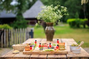 a wooden table topped with food on a cutting board at Siedlisko Sobibór in Sobibór