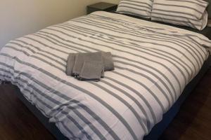 a bed with two towels sitting on top of it at Apartment Sleeps 2 in Leigh