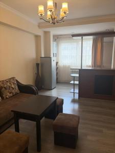 a living room with a couch and a table at Republiq Apartment in City Ceneter in Yerevan
