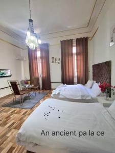 a bedroom with a large bed and a dining room at An ancient pal ace in Cairo
