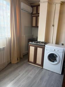 a washer and dryer in a small room at Republiq Apartment in City Ceneter in Yerevan