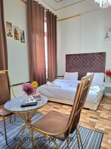 a bedroom with a bed and a table and a bed at An ancient pal ace in Cairo