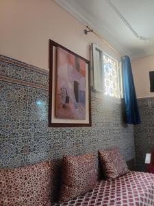 a bedroom with a bed and a picture on the wall at La Perle in Meknès +5 photos