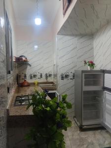 a kitchen with a sink and a stove in it at La Perle in Meknès